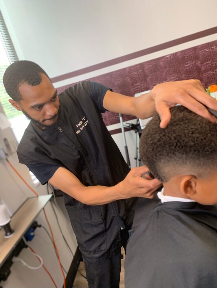 Talib T cutting a client in his private suite, Laurel MD